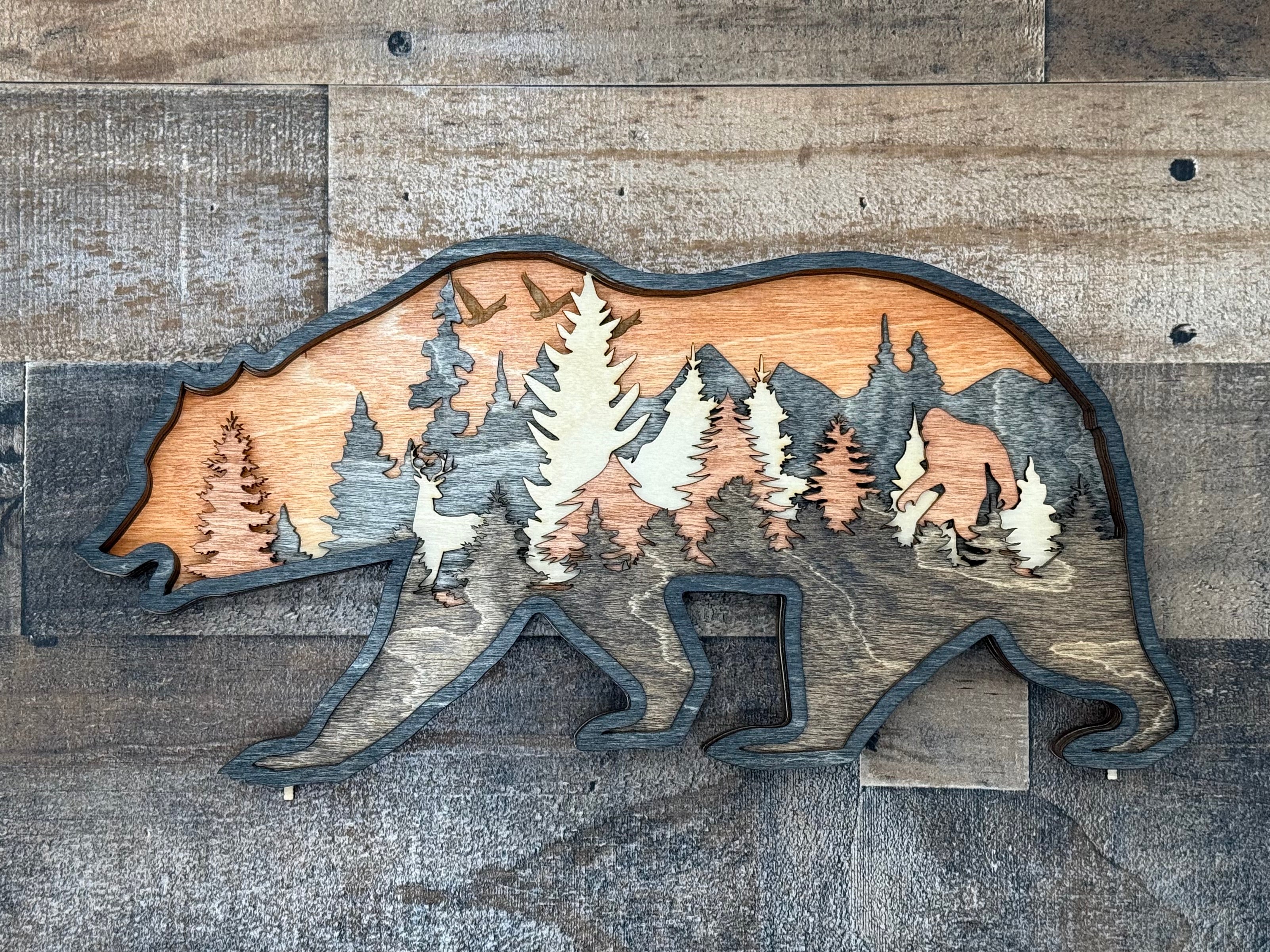 Bear, deer, and mysterious sasquatch in a forest clearing – multilayer laser cut wood art by Laser Lakes