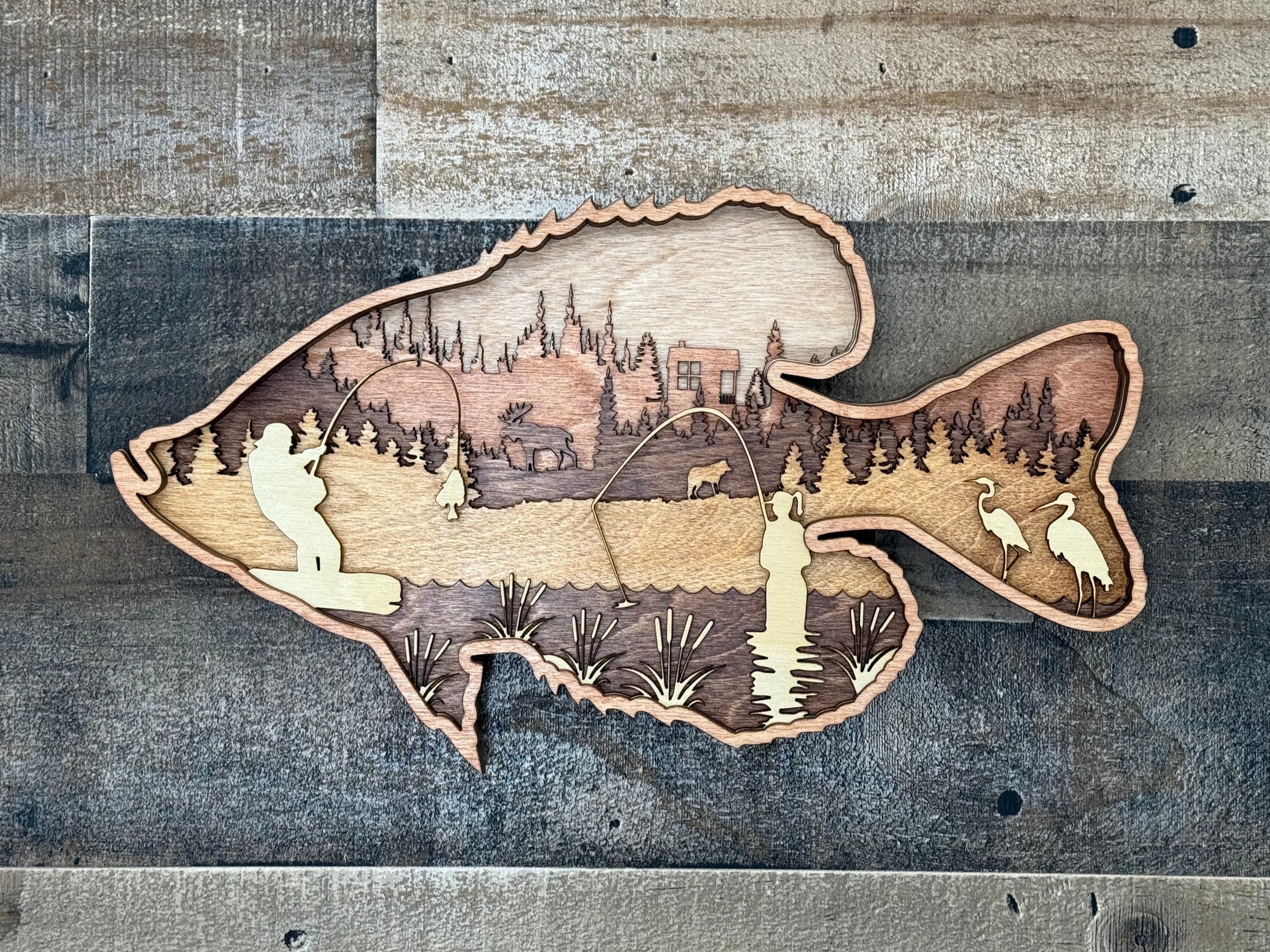 Crappie fishing scene: man and woman with a wolf and moose nearby – 7-layer laser cut wood art by Laser Lakes