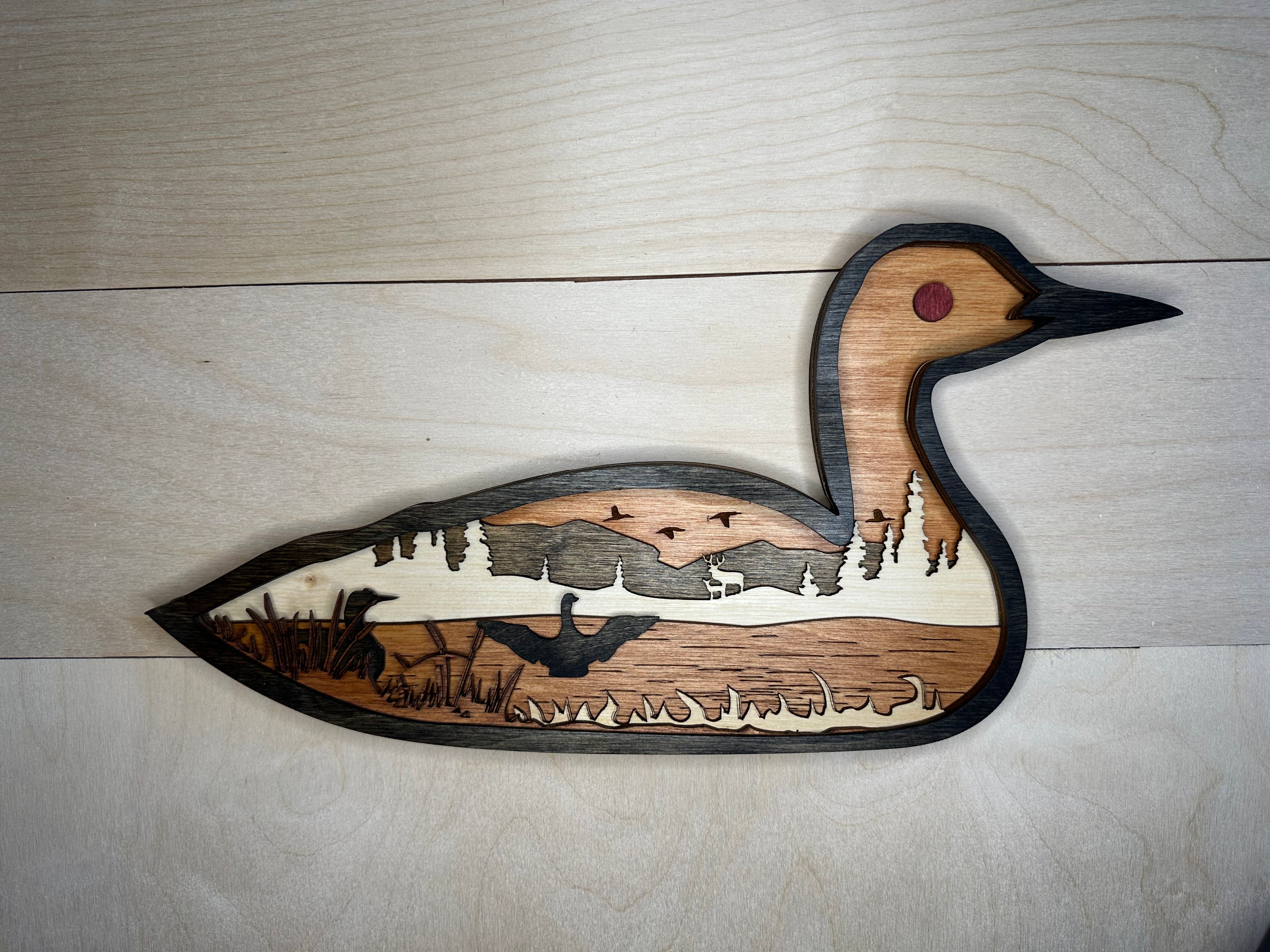Loon detail: intricate laser cuts showing the bird's distinctive markings
