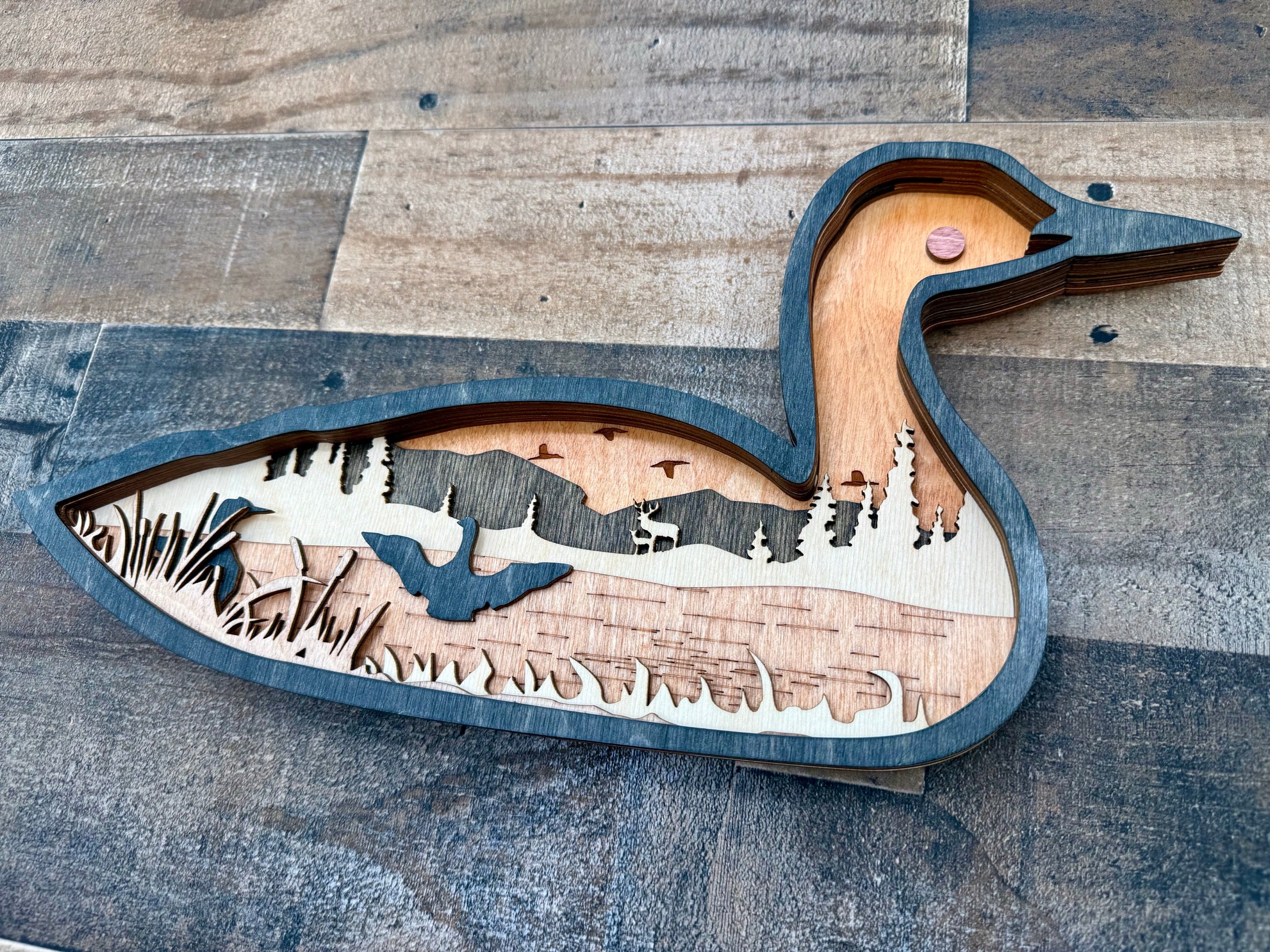 Loon detail: layered wood texture revealing dimensional craftsmanship