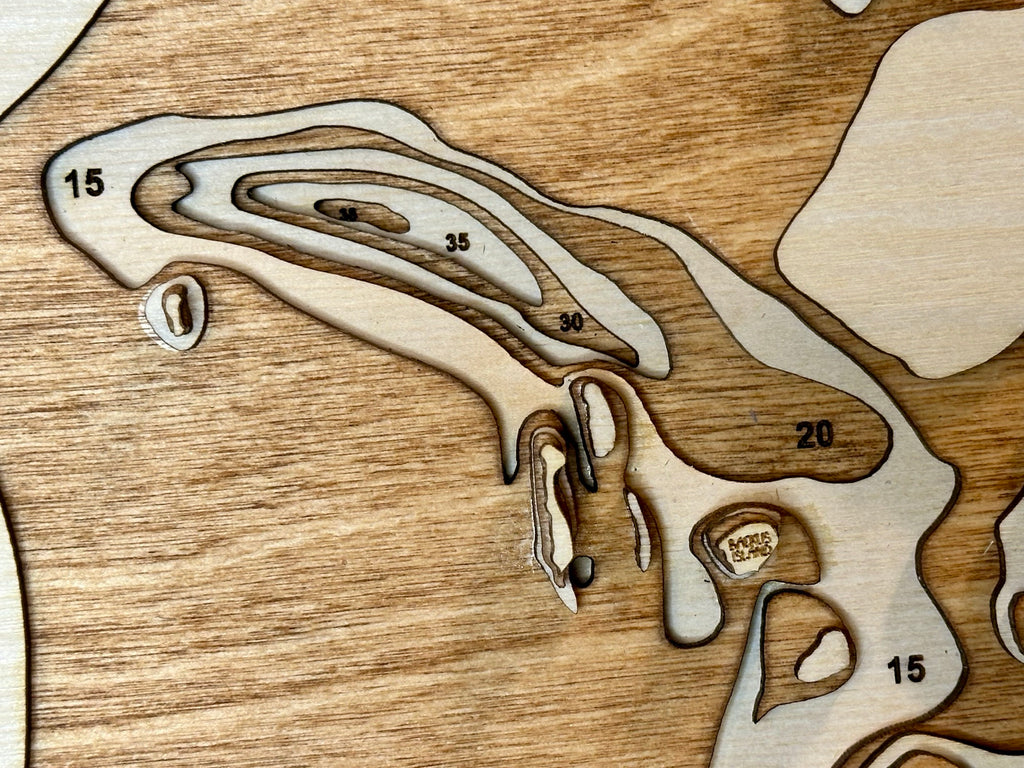 Pelican Lake topographic map showing laser-engraved depth contours in wood