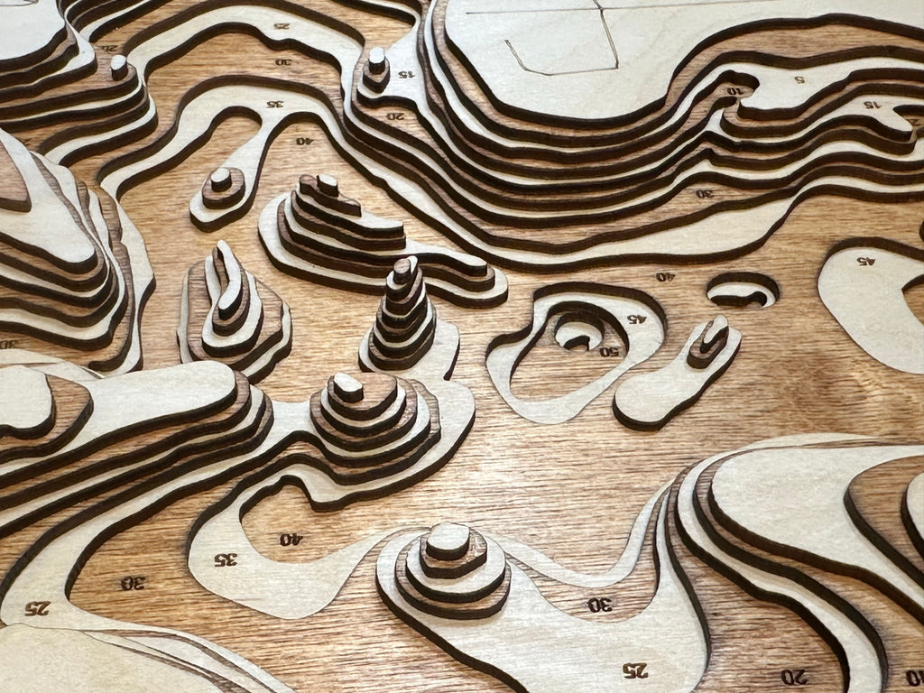 Serpent Lake topographic map showing laser-engraved contours in wood