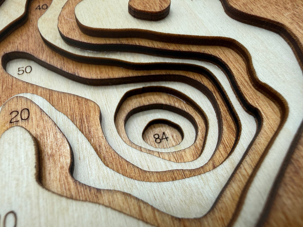 Laser-cut wood topographic map of Webb Lake Cass County Minnesota with engraved depth contours showing 84ft