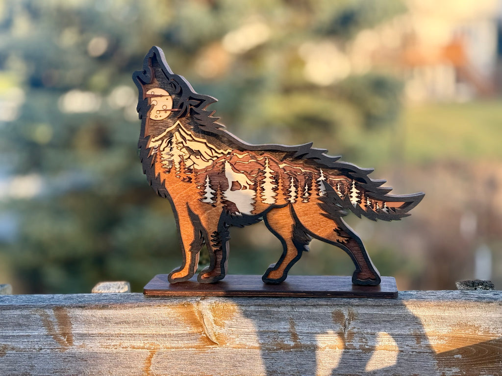 Wolf Song Dark wood light in stand showing laser-engraved layers with wolf silhouette