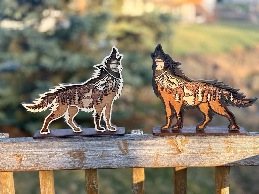 Wolf Song Dark and Light wood lights displayed together showing contrasting laser-engraved designs